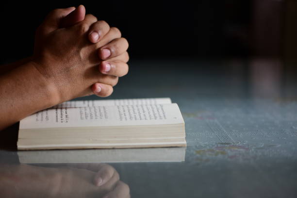 praying hands of a man with faith in religion